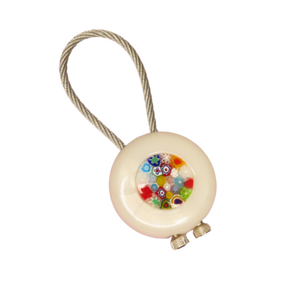 Round keychain with colorful millefiori bead on a white background