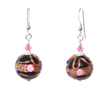 A pair of Murano glass black wedding cake silver earrings with pink Swarovski crystals and sterling silver findings, displayed against a white background.