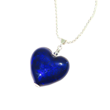 A cobalt blue Murano glass puffy heart pendant on a silver chain with a sterling silver bail and lobster claw clasp.