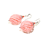 a pair of orange and pink earrings on a white background
