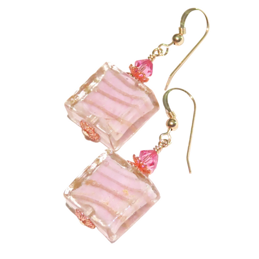 a pair of pink earrings with pink beads