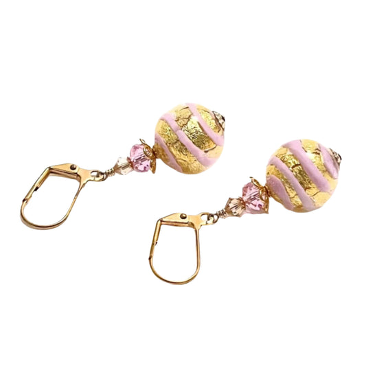 Pair of earrings with gold and pink beads on a white background