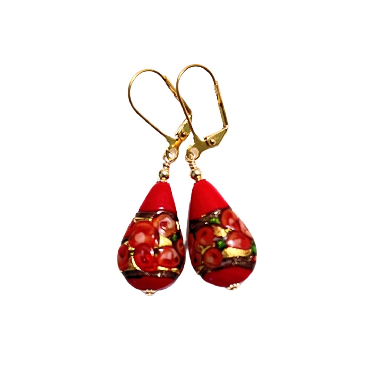 a pair of red and gold earrings on a white background